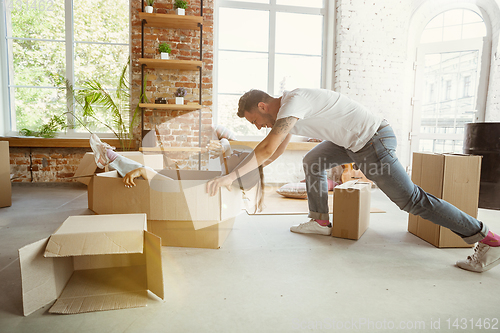 Image of Young couple moved to a new house or apartment