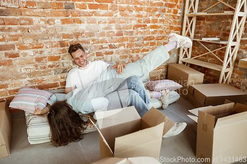 Image of Young couple moved to a new house or apartment