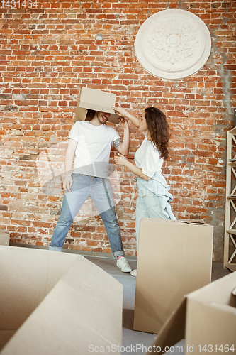 Image of Young couple moved to a new house or apartment