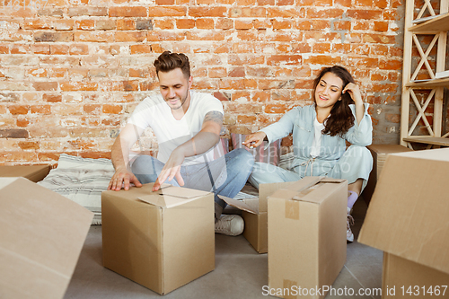 Image of Young couple moved to a new house or apartment