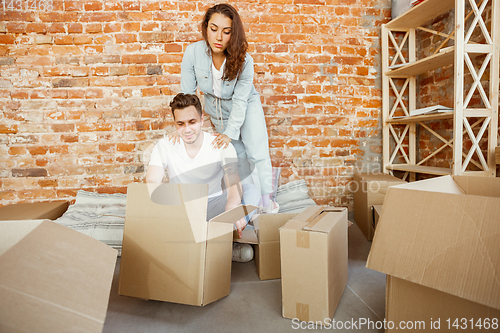 Image of Young couple moved to a new house or apartment