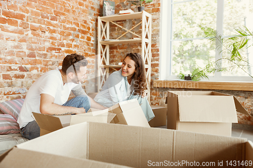 Image of Young couple moved to a new house or apartment
