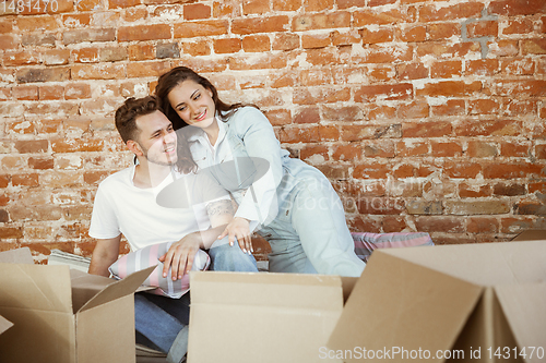 Image of Young couple moved to a new house or apartment