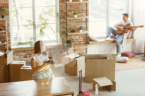 Image of Young couple moved to a new house or apartment