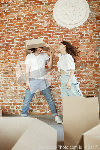 Image of Young couple moved to a new house or apartment