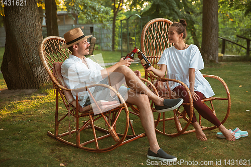 Image of Happy couple at barbecue dinner on sunset time
