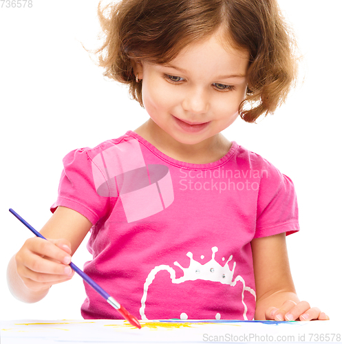 Image of Little girl is painting with gouache