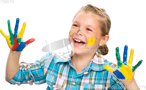 Image of Portrait of a cute girl playing with paints