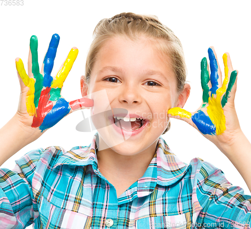 Image of Portrait of a cute girl playing with paints