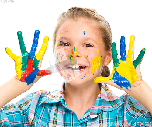 Image of Portrait of a cute girl playing with paints