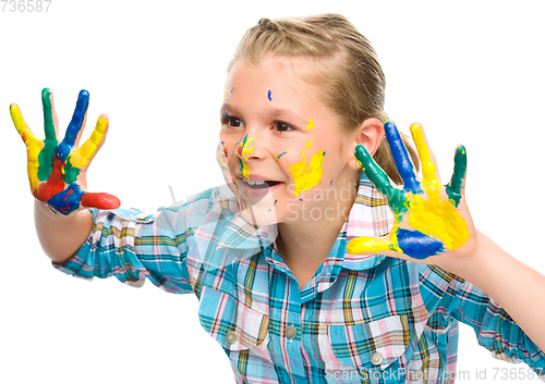 Image of Portrait of a cute girl playing with paints