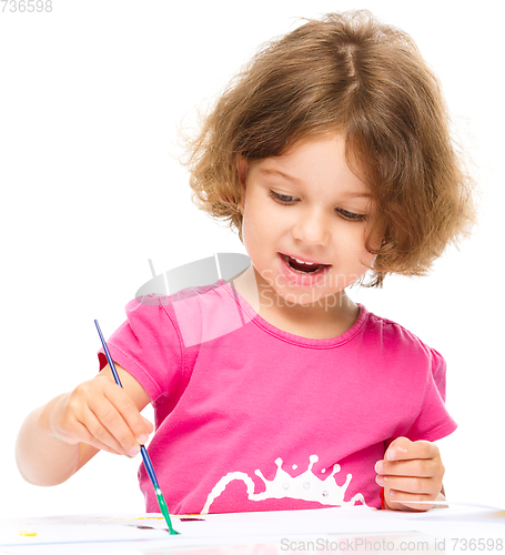 Image of Little girl is painting with gouache