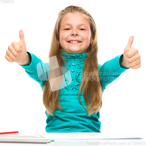 Image of Little girl is showing thumb up sign