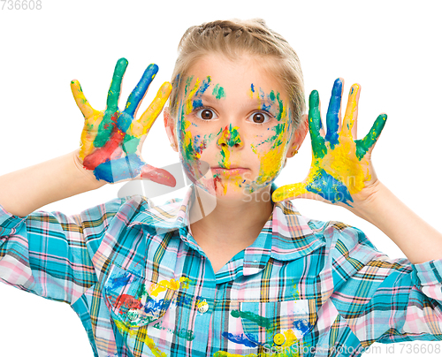 Image of Portrait of a cute girl playing with paints