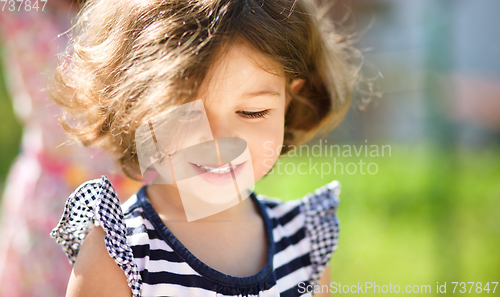 Image of Cute little girl is playing in playground