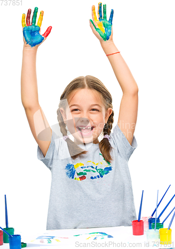 Image of Portrait of a cute girl playing with paints