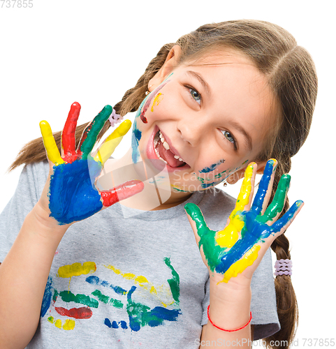 Image of Portrait of a cute girl playing with paints
