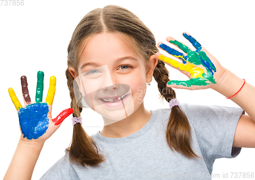 Image of Portrait of a cute girl playing with paints