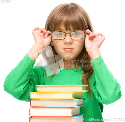 Image of Little girl is reading a book