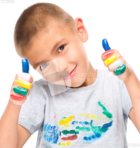 Image of Portrait of a cute boy playing with paints