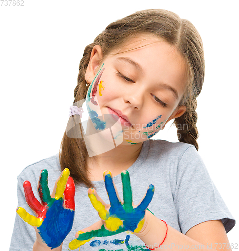 Image of Portrait of a cute girl playing with paints