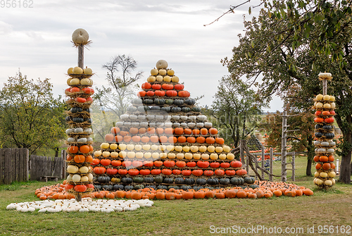 Image of Autumn harvested pumpkins arranged for fun like pyramid