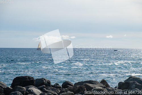 Image of sail boat at horizon line