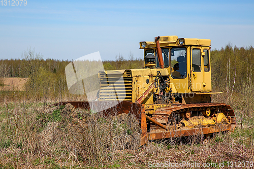 Image of Old crawler tractor in the field.