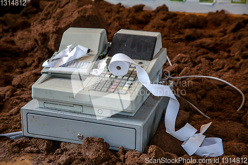 Image of Old cash register with cash register tape. 