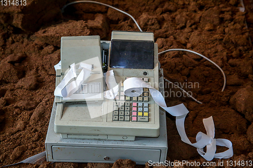 Image of Old cash register with cash register tape. 