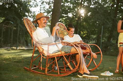 Image of Happy couple at barbecue dinner on sunset time