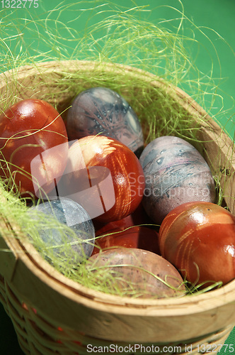 Image of Painted eggs on green background.