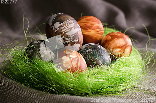 Image of Painted eggs in green socket.