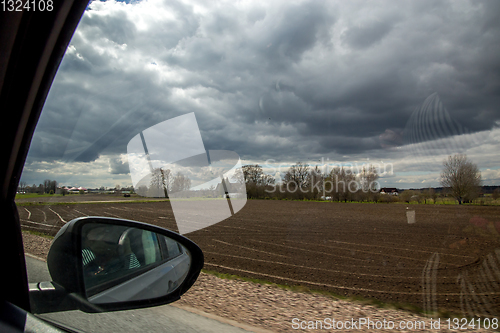 Image of View of plowed field from the window of the car.