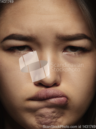 Image of Close up portrait of young emotional woman