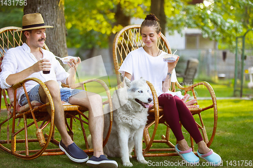 Image of Happy couple at barbecue dinner on sunset time