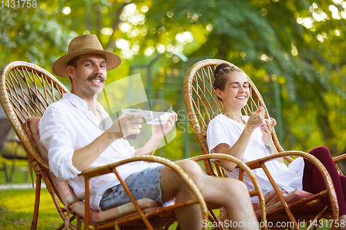 Image of Happy couple at barbecue dinner on sunset time