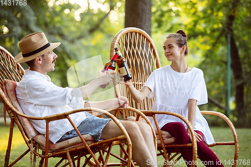 Image of Happy couple at barbecue dinner on sunset time