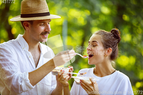 Image of Happy couple at barbecue dinner on sunset time