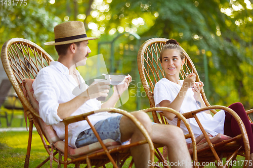 Image of Happy couple at barbecue dinner on sunset time