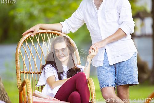 Image of Happy couple at barbecue dinner on sunset time