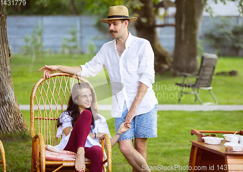 Image of Happy couple at barbecue dinner on sunset time