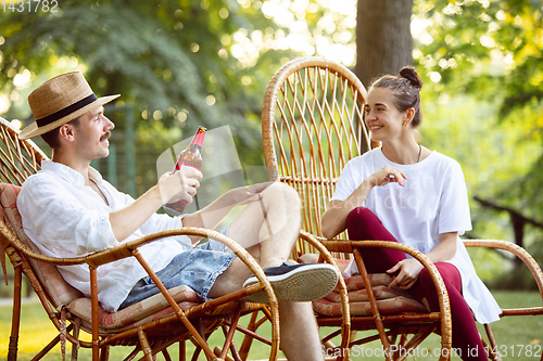 Image of Happy couple at barbecue dinner on sunset time