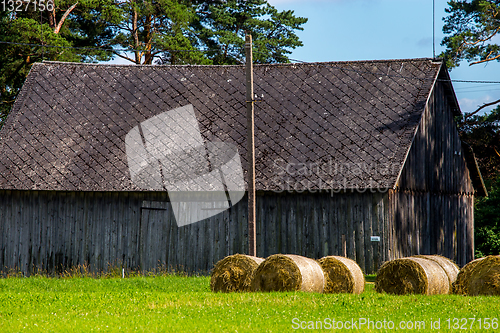 Image of Hay bales in the meadow near the barn.