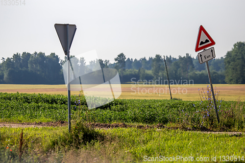 Image of Road signs next to the rural road.