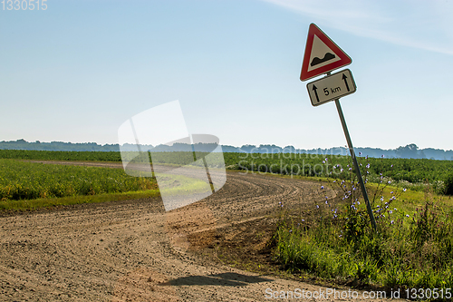 Image of Road sign next to the rural road.