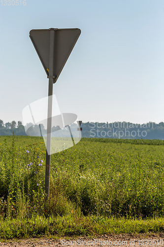 Image of Road sign next to the rural road.