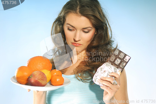 Image of A woman with fruits and chocolate