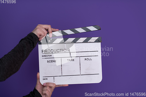 Image of movie clapper on purple background