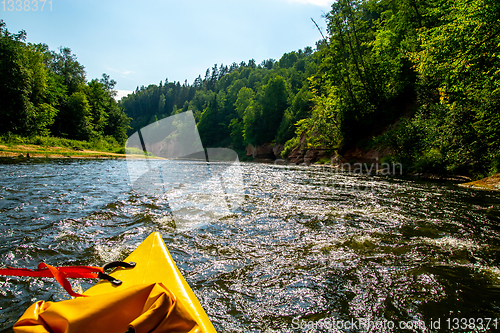 Image of Yellow boat ride by the river.